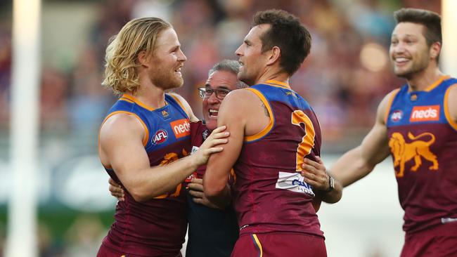 Brisbane coach Chris Fagan celebrates the Lions epic win over the Cats with Daniel Rich and Luke Hodge. Picture: Getty Images