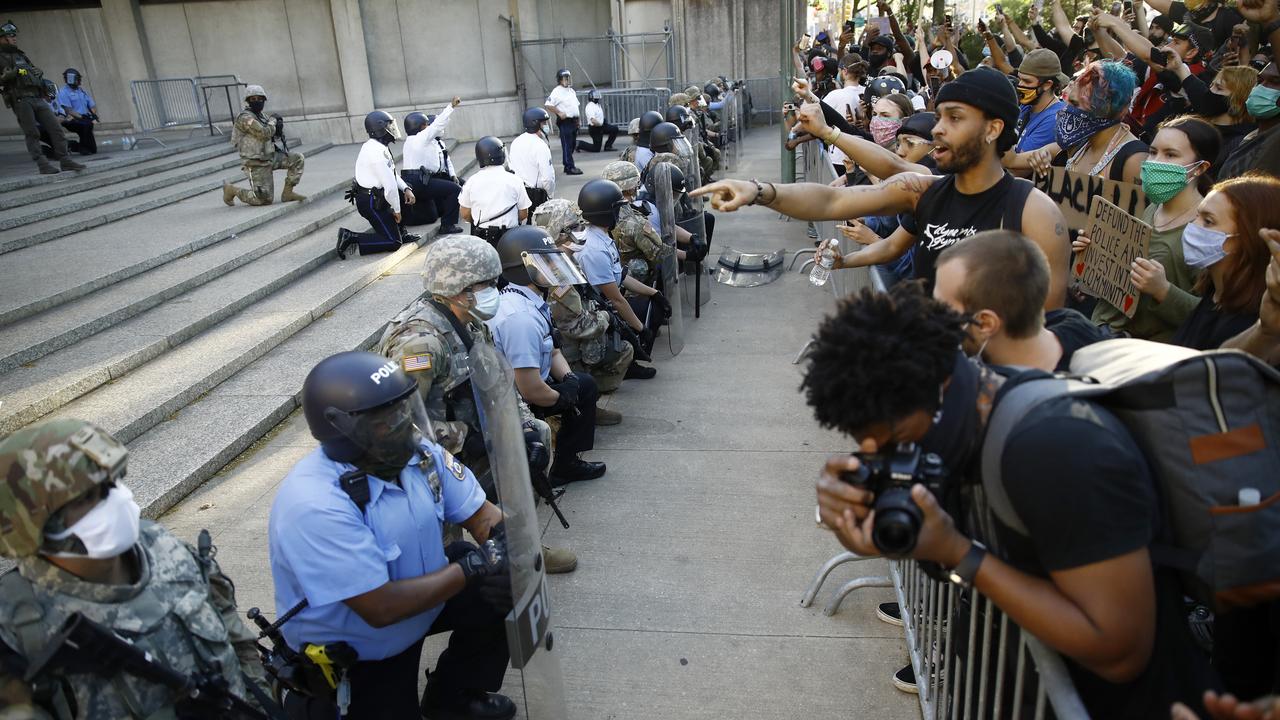 Philadelphia police and National Guard take a knee at the suggestion of Philadelphia Police Deputy Commissioner Melvin Singleton outside the police headquarters. Picture: Matt Slocum/AP