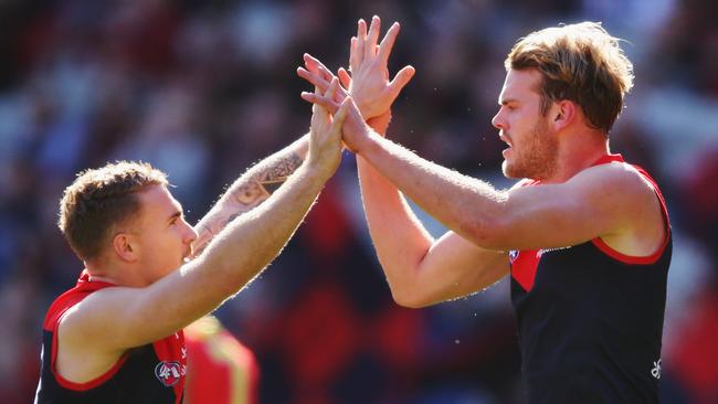 Dean Kent of the Demons and Jack Watts celebrate a goal against the Suns