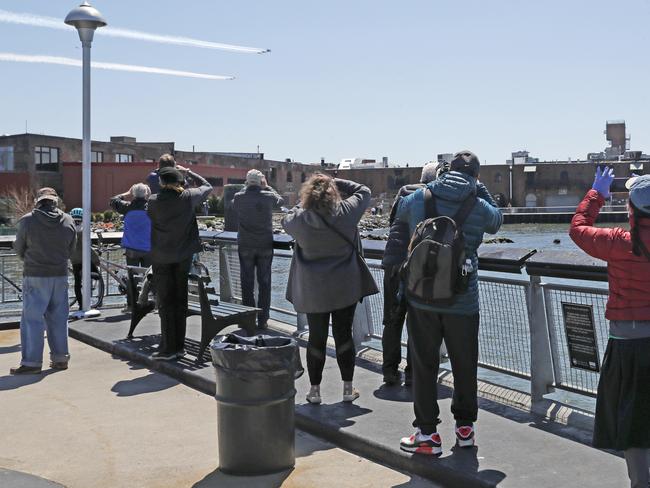 New Yorkers weren’t too worried about social distancing as they watched a flyover. Picture: AP