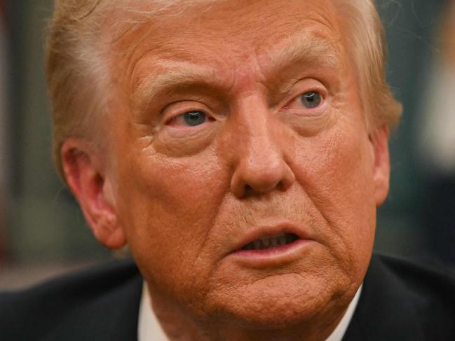 US President Donald Trump speaks to journalists as he signs executive orders in the Oval Office of the WHite House in Washington, DC, on January 20, 2025. (Photo by Jim WATSON / POOL / AFP)