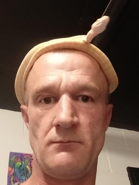 Nydegger, pictured wearing a snake as a hat in an undated social media photo, will be eligible to apply for parole in 2026.