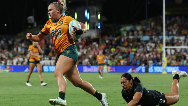 Heidi Dennis escapes the clutches of a rival to run in one of her two tries in Perth. Picture: Will Russell/Getty Images