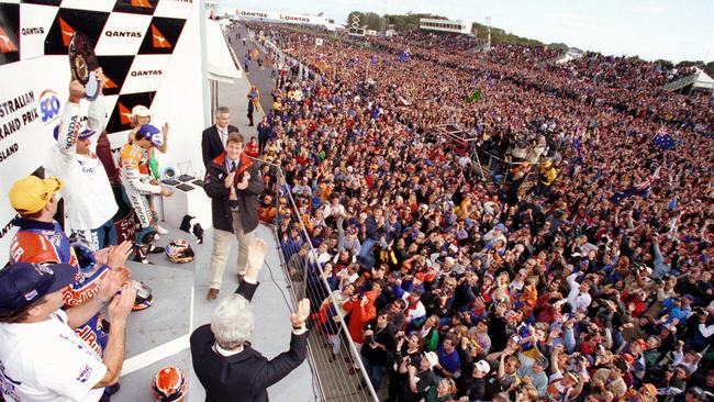 Thousands of fans salute Mick Doohan on the podium at Phillip Island.