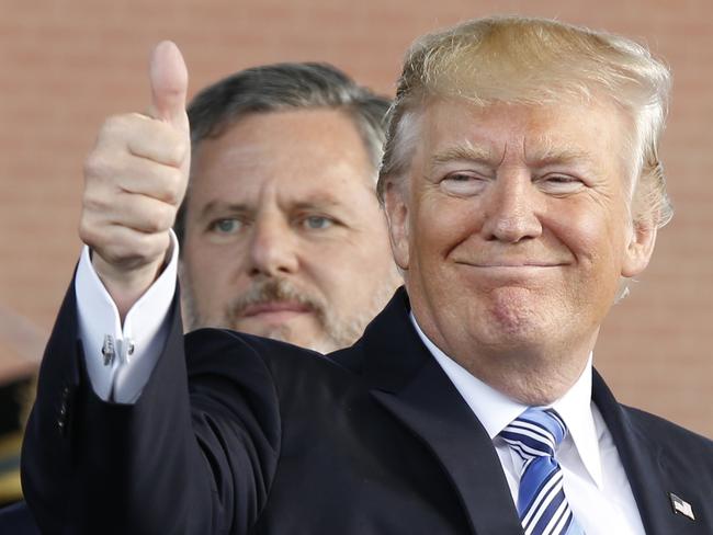 President Donald Trump, right, gives a thumbs up as Liberty University president, Jerry Falwell Jr., left, watches during of commencement ceremonies at the school in Lynchburg, Va., Saturday, May 13, 2017. (AP Photo/Steve Helber)