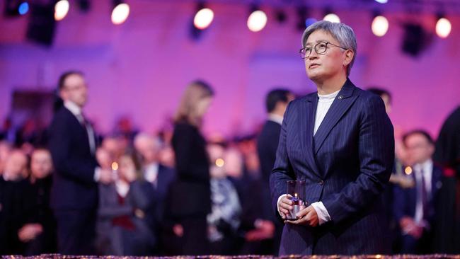 Australian Foreign Minister Penny Wong places a candle in front of the train car, the symbol of the event, to pay tribute to the victims during commemorations on the 80th anniversary of the liberation of the German Nazi concentration and extermination camp Auschwitz-Birkenau.