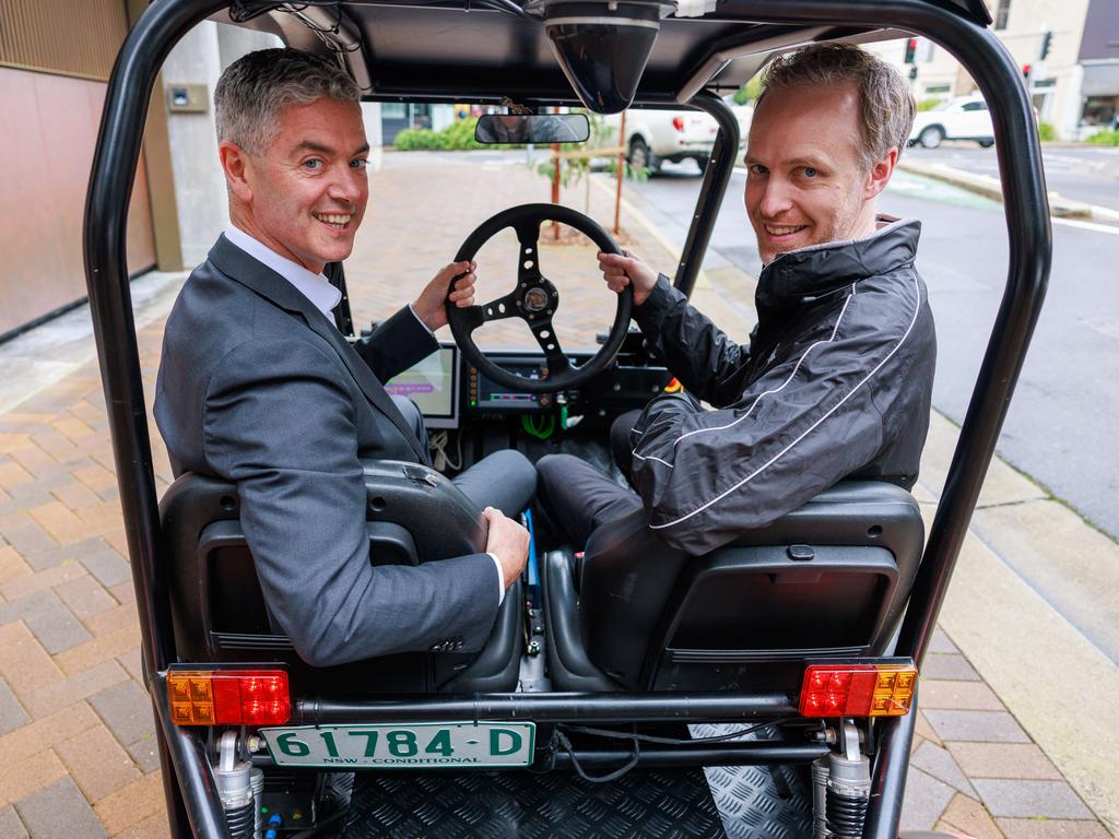 NSW Roads Minister John Graham and Stewart Worrall from the Australian Centre for Field Robotics during the driverless vehicle trial. Picture: Justin Lloyd