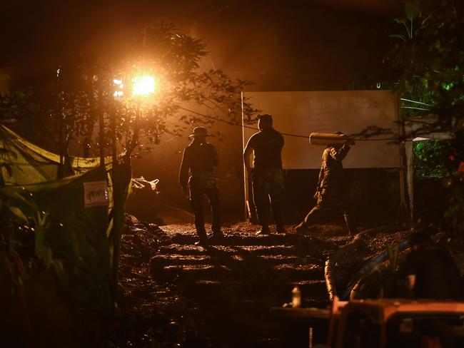 Rescue workers carry oxygen tanks to Tham Luang cave. Picture: AFP