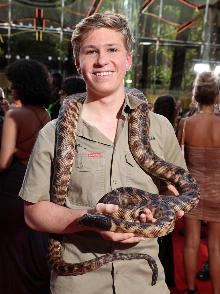 Robert Irwin arrives with a snake in tow. Picture: Jonathan Ng