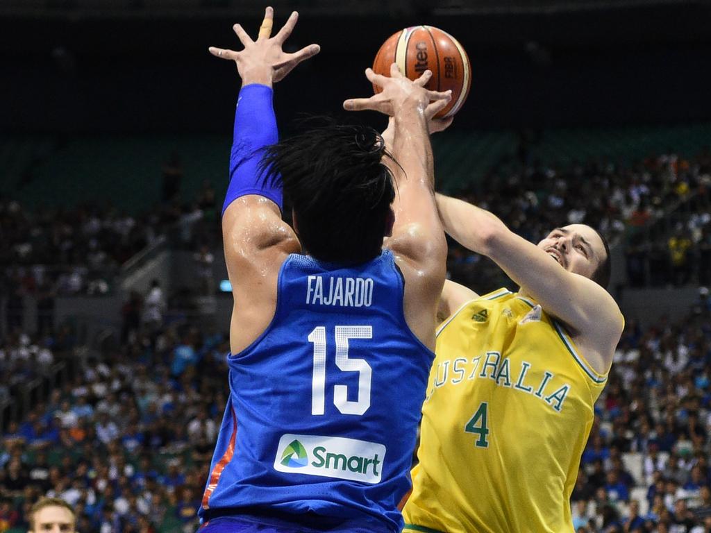 Philippine's June Fajardo (#15) blocks a shot by Australia's Christopher Goulding during their FIBA World Cup Asian qualifier game at the Philippine arena in Bocaue town, Bulacan province, north of Manila on July 2, 2018. Australia won by default 89-53. / AFP PHOTO / TED ALJIBE