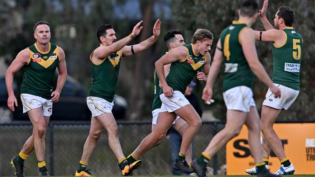 Old Eltham Collegians players celebrate a goal. Picture: Andy Brownbill