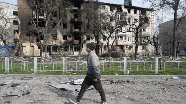 A man walks near a residential building destroyed in Mariupol on April 17. Picture: Victor/Xinhua via Getty Images