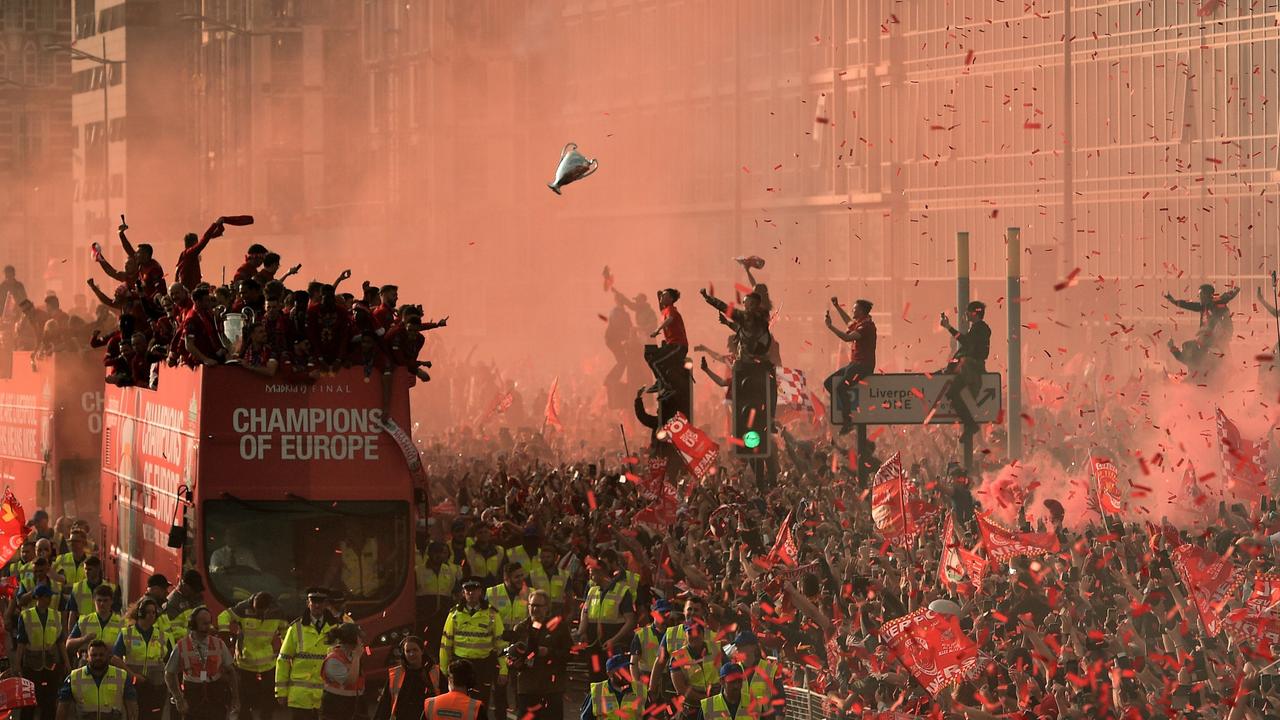 Fans in Liverpool celebrate as Liverpool players parade the European Cup following last season’s Champions League win. Picture: AFP