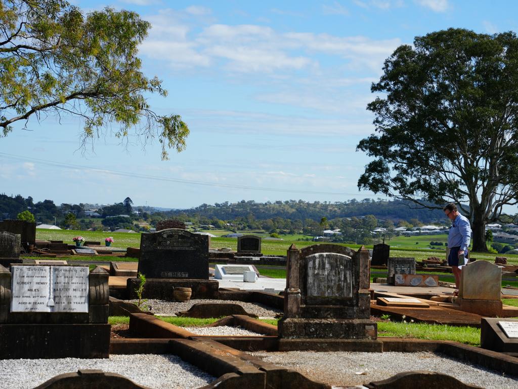 Michael Wagner working to restore the gravestones in Drayton Cemetery that were vandalised last year, as part of the Headstone Healing Project.