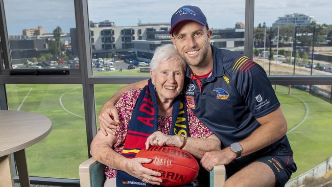 Brodie Smith who plays his 250th game for the Crows with his biggest fan his Grandmother Josie Franklin,85, who lives in the SA Uniting nursing home that looks over the Crows training ground where she watches her grandson train .Monday,March,25,2024.Picture Mark Brake