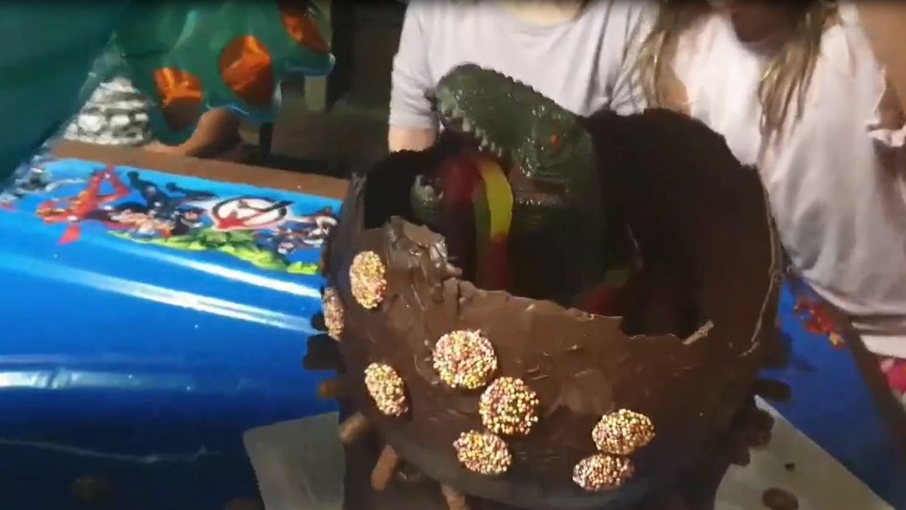 The dinosaur hiding inside the cake.