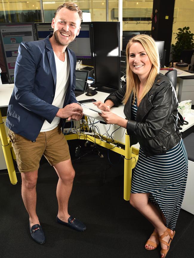 Seek employees Jack McLean and Stephanie Paul use both sitting and standing desks in their office. Picture: Ellen Smith