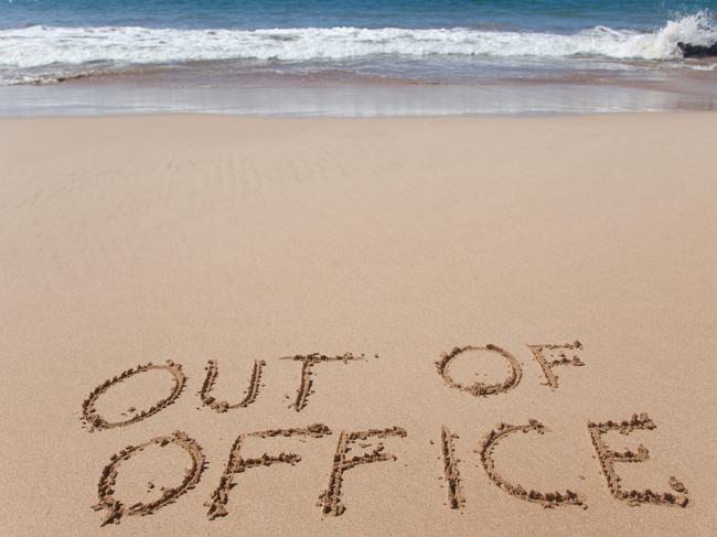 Out of office. A simple concept image written in the sand on a beautiful Hawaii beach.