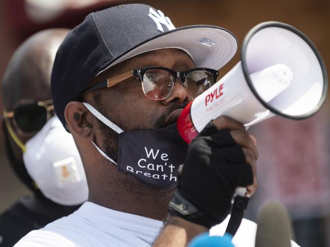 Terrence Floyd, centre, speaks to a group gathered at the site where his brother George Floyd was tackled by police one week ago. Picture: Getty Images/AFP