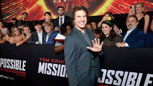 Tom Cruise poses with fans during the US premiere of ‘Mission: Impossible—Dead Reckoning Part One’ in New York City on July 10, before the actors’ strike put an end to stars on the red carpet. PHOTO: JASON MENDEZ/GETTY IMAGES