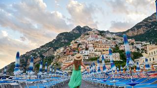 ESCAPE: Cover Option, Jan 27 -  Italian vacations series. Young woman admiring the view of Positano village on Amalfi coast Picture: Istock