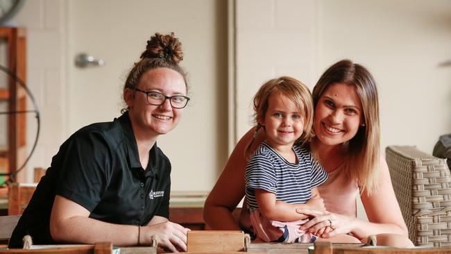 Working parent Gemma Chohdri, right, her daughter Elsie, 2, and childcare worker Emma Steinbeck, left, are pleased that childcare will be supported during the coronavirus crisis. Picture: Glenn Campbell