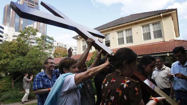 Christians carry the cross at Mary MacKillop Place during World Youth Day celebrations.