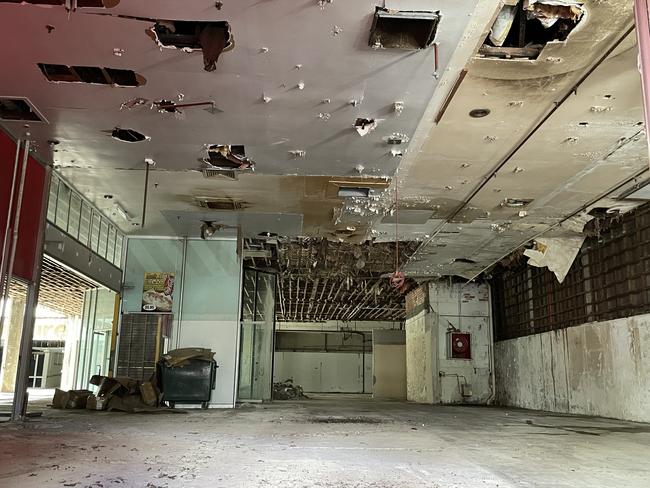 A broken window revealed the crumbling interior inside the former Dimmeys Arcade. Picture: Leighton Smith.