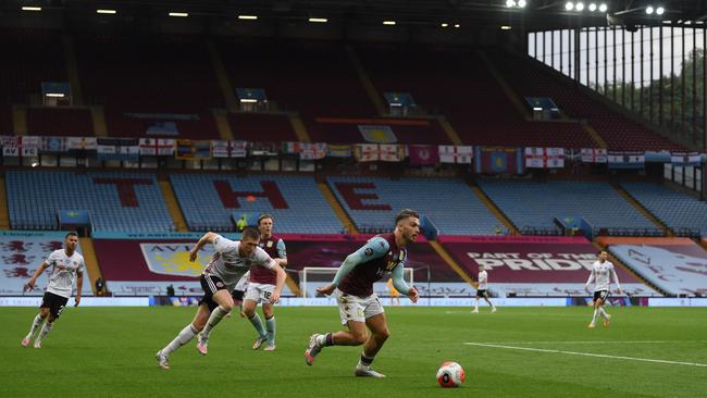 Aston Villa’s English midfielder Jack Grealish runs with the ball as empty stands are seen in the background at Villa Park during the English Premier League football match against Sheffield United. Picture: AFP