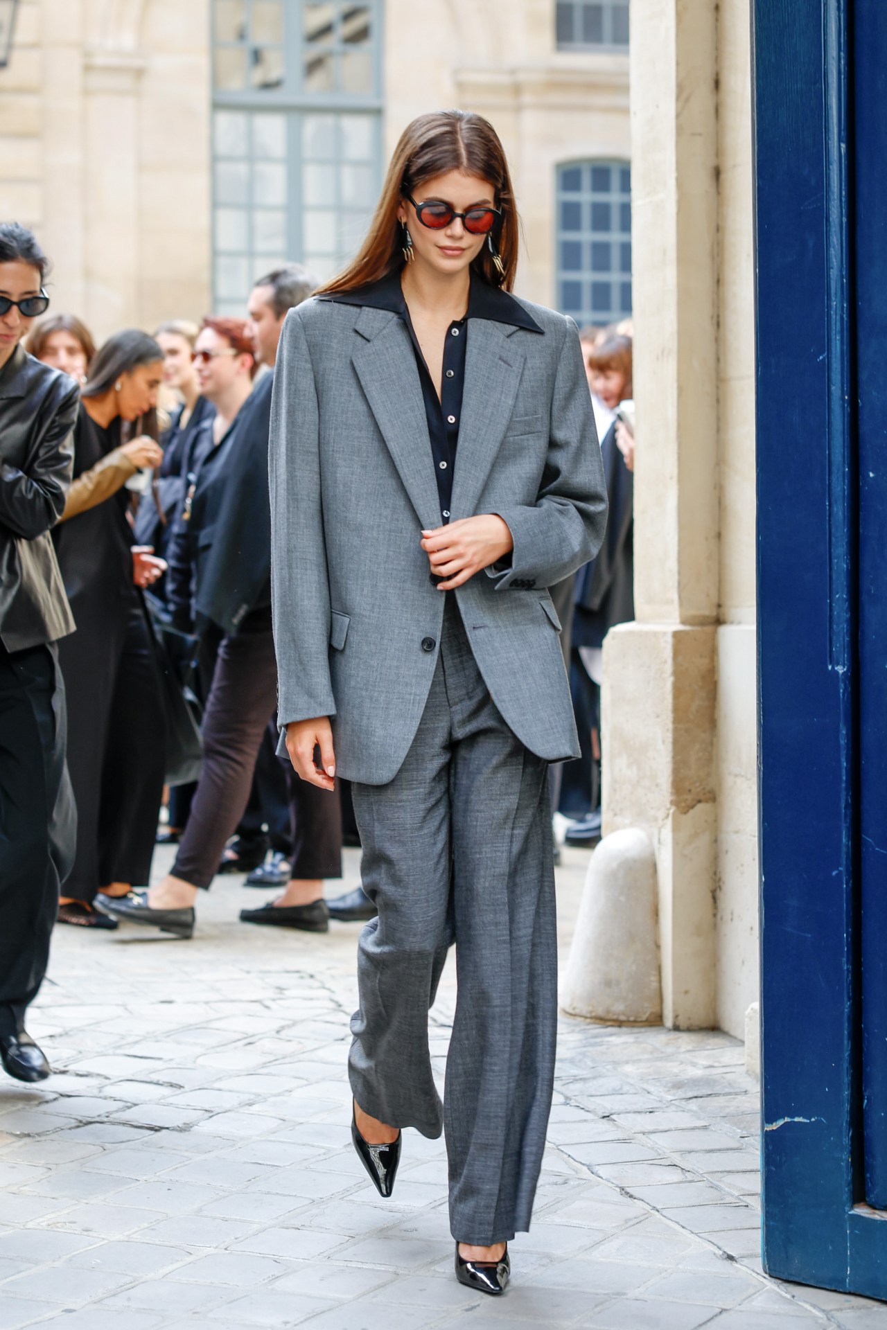 <p><em>Image credits: Getty Images&nbsp;</em></p><p>&nbsp;</p><p>Borrowing from Butler was girlfriend Kaia Gerber, showing that statement suits weren&rsquo;t limited to the men at fashion month. Gerber&rsquo;s take was very much in line with Butler&rsquo;s MO, slightly oversized with a blouse underneath worn like one of Butler&rsquo;s many open-collar shirts&mdash;collar splayed out over the lapel. It was a little gangster, it was a little &rsquo;70s, and it was another great looking suit.&nbsp;</p><p>&nbsp;</p>