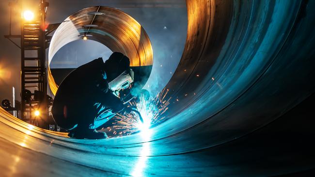 The welder is welding steel plates