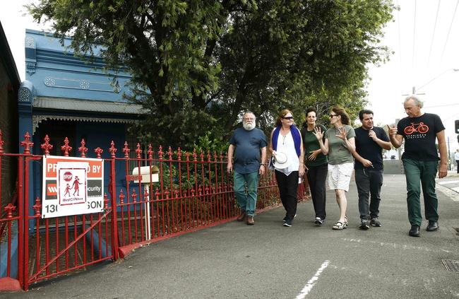 John Todhunter, Monette Lee, Denise Corrigan, Margaret Carter, Mark Crpriana, and David Watson walk past some of the vacant properties on Victoria Rd at Rozelle. Picture: John Appleyard