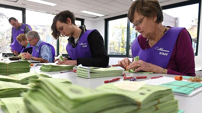 Temporary Australian Electoral Commission workers count votes in Sydney. Electronic voting could mean these roles are redundant and the election result is know in minutes.