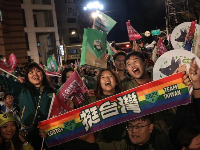 Supporters react after Taiwan's Vice President and presidential candidate of ruling Democratic Progressive Party (DPP) Lai Ching-te won the presidential election outside the party's headquarters in Taipei on January 13, 2024. Taiwan's ruling party candidate Lai Ching-te, branded a threat to peace by China, on January 13 won the island's presidential election, a vote watched closely from Beijing to Washington. (Photo by Yasuyoshi CHIBA / AFP)