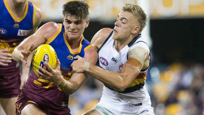 Hugh Greenwood tackles Ben Keays in his debut AFL game against Brisbane last weekend. Picture: AAP Image