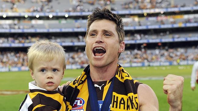 Shane Crawford, seen here with son Charlie after the 2008 premiership win, had a long and distinguished career as a Hawk after b