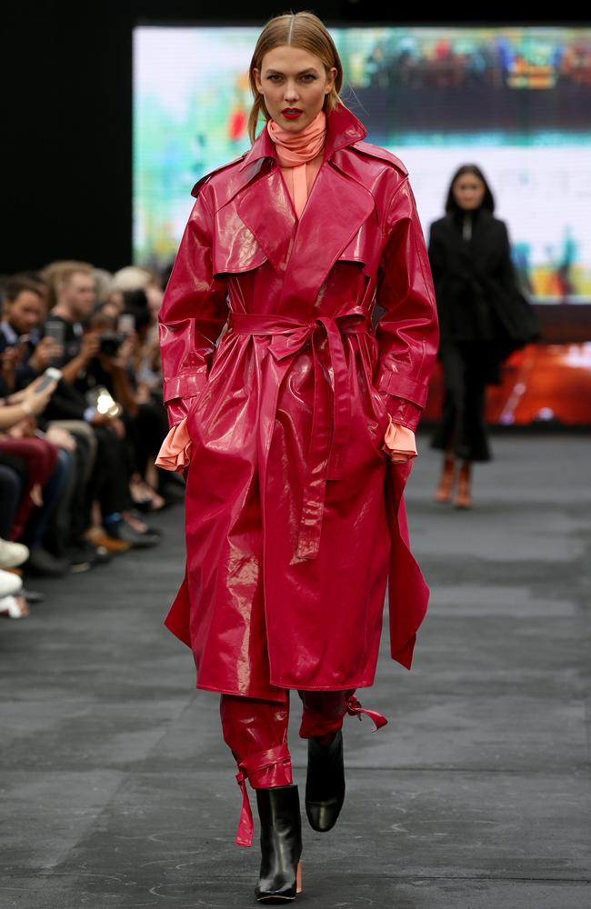 Karlie wears a patent magenta trench and matching trousers. Picture: Jonathan Ng