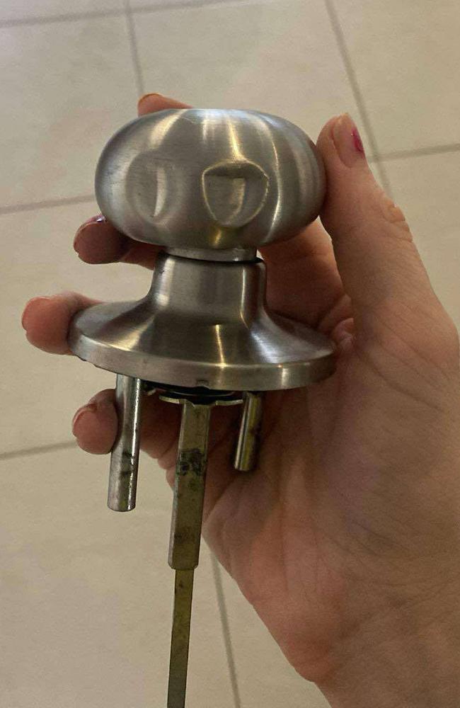 The laundry door's handle, which was clamped onto with a tool and pulled until the lock mechanism snapped, allowing entry. Marks from the tool can be seen.
