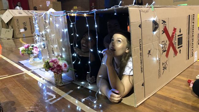 Year 12 students (from left) Sewmini Malalgama, Sophie Morris and Eloise Cansdell settle into their makeshift home for the night.