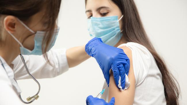 Close up doctor or nurse giving vaccine to patient using the syringe injected in hospital