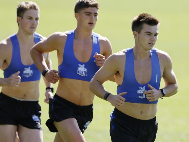 North Melbourne training at Arden St oval. Colby McKercher leads Harry Sheezel and Tom Powell on his way to comfortably winning the 2km time trial on the first official day back for the 1-4 year players . Picture: Michael Klein