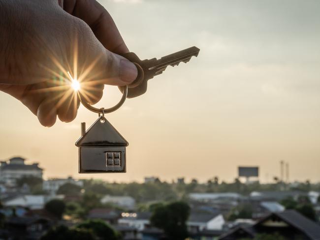 House model and key in home insurance broker agent  hand or in salesman person. Real estate agent offer house, property insurance and security, affordable housing concepts. Property investing, investment. Source: istock - for Herald Sun realestate