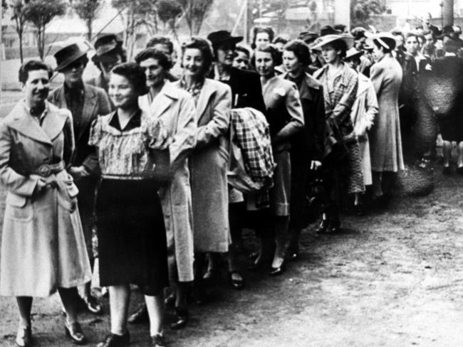 Women volunteers line up waiting for instructions on their first day in the Australian Women's Army Service during WWII.