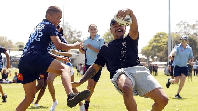 Latrell Mitchell is all smiles as are the kids. Picture: Sam Ruttyn