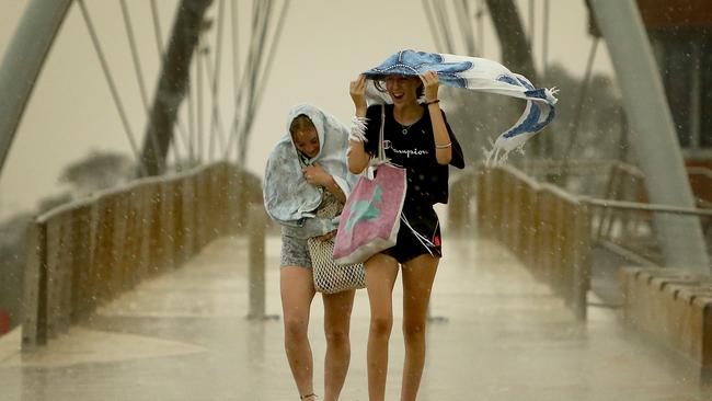 People scramble to take cover in Frankston as a storm front ripped through yesterday. Picture: Stuart McEvoy/The Australian