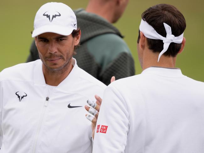 LONDON, ENGLAND - JULY 07: Rafael Nadal of Spain greets Roger Federer of Switzerland during a practice session during Middle Sunday of The Championships - Wimbledon 2019 at All England Lawn Tennis and Croquet Club on July 07, 2019 in London, England. (Photo by Matthias Hangst/Getty Images)