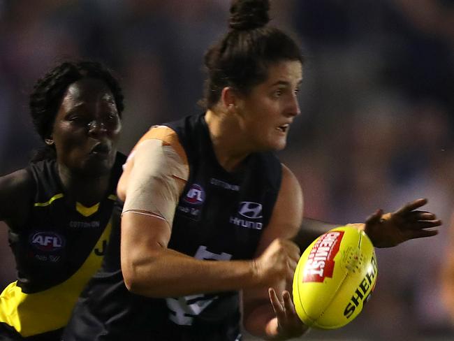 MELBOURNE, AUSTRALIA - FEBRUARY 07: Lucy McEvoy of the Blues handballs during the round one AFLW match between the Richmond Tigers and the Carlton Blues at Ikon Park on February 07, 2020 in Melbourne, Australia. (Photo by Kelly Defina/Getty Images)