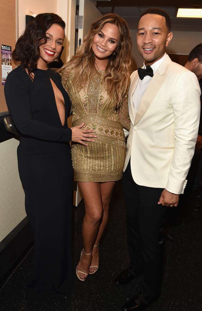 LAS VEGAS, NV - DECEMBER 02: Singers Alicia Keys (L) and John Legend (R) and model Chrissy Teigen (C) pose backstage during 