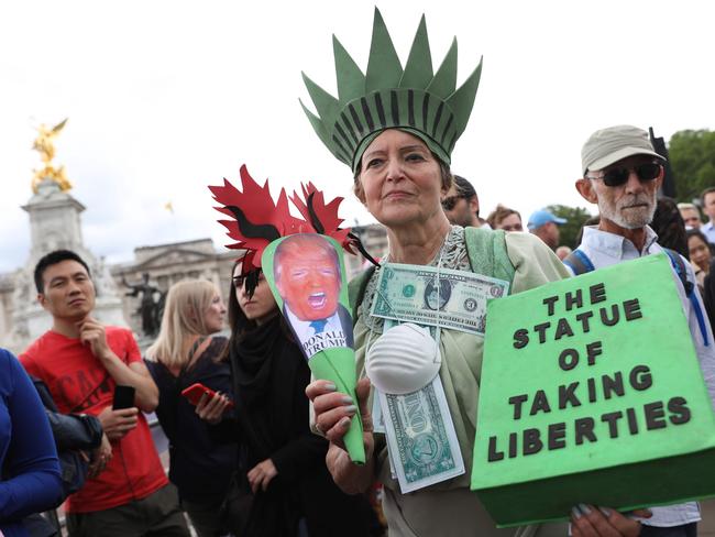 A woman protests outside Buckingham Palace in central London on Monday, the first day of Donald Trump’s three-day state visit to the UK. Picture: Isabel Infantes / AFP