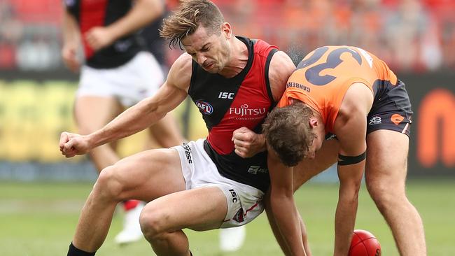 SYDNEY, AUSTRALIA — MARCH 24: Patrick Ambrose of the Bombers challenges Harry Perryman of the Giants during the round one AFL match between the Greater Western Sydney Giants and the Essendon Bombers at GIANTS Stadium on March 24, 2019 in Sydney, Australia. (Photo by Mark Metcalfe/AFL Photos/Getty Images)